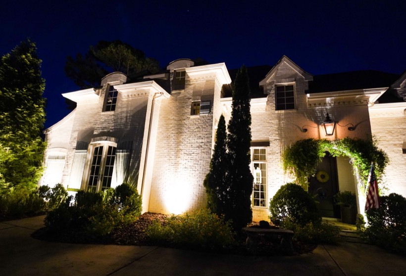 Featured Property home with professional outdoor lighting