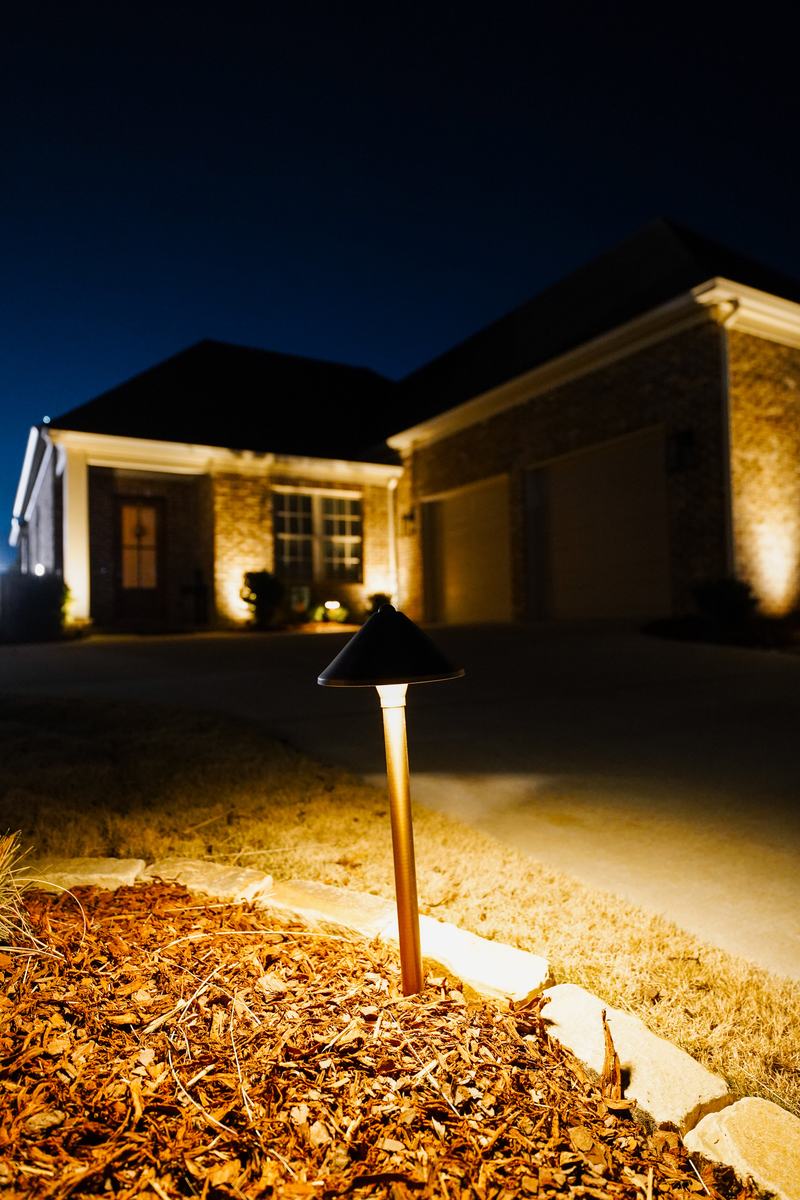 Path & Walkway Lighting project — Path light in foreground, lit brick house behind (pro)