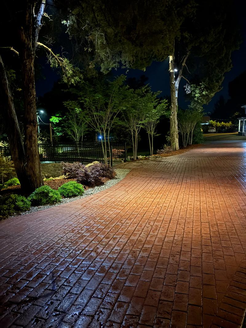 Path & Walkway Lighting project — Wet brick drive court, landscape lighting all around