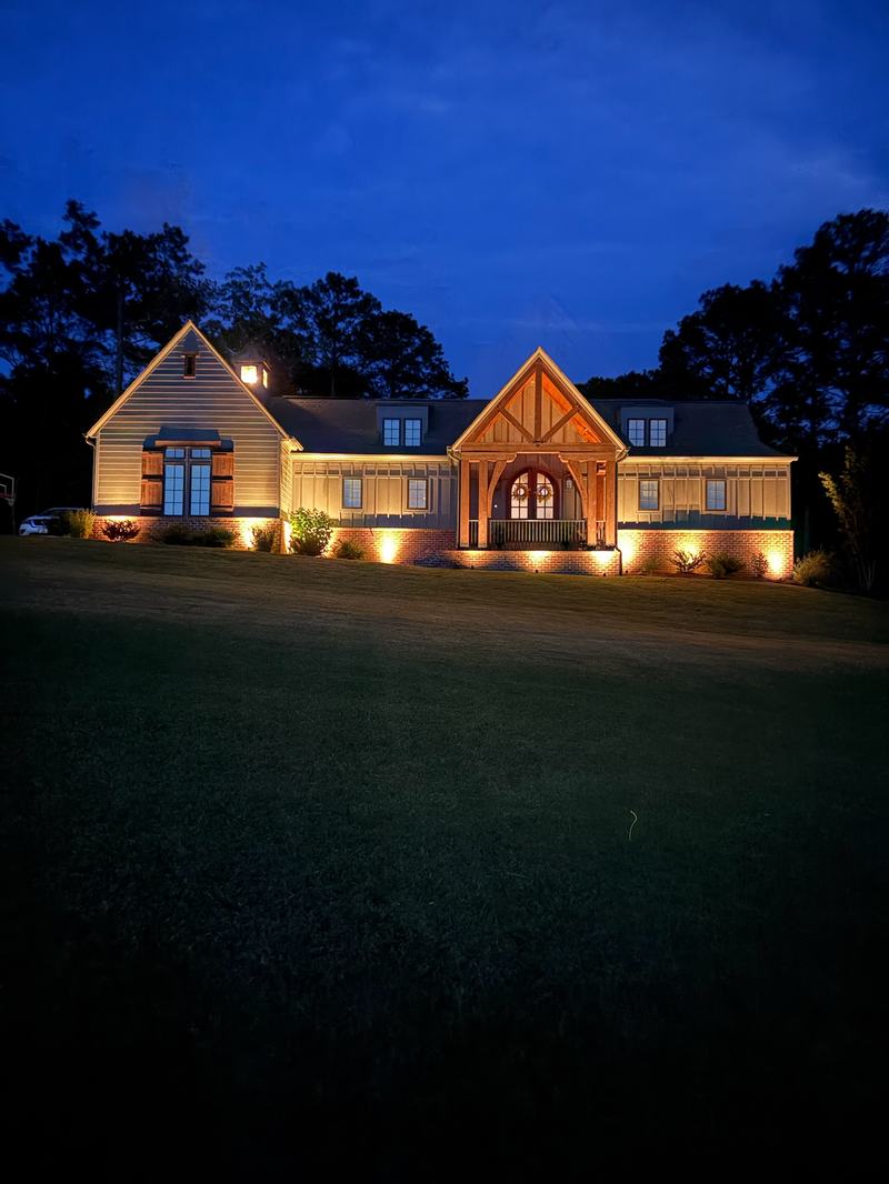 Architectural & Front-of-House Uplighting project — Rustic gabled house, warm entry arch uplights